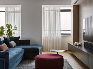 A living room with velvet blue sofa