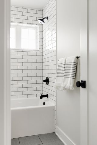 white metro tiled bathroom with tub and shower over tub