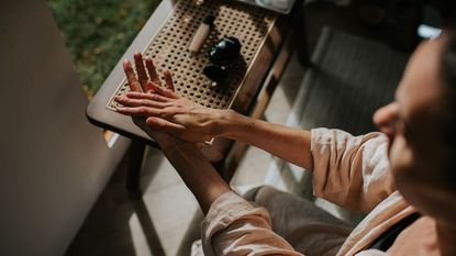 A woman moisturises her hands