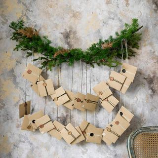 Handmade advent calendar hung from fir branch