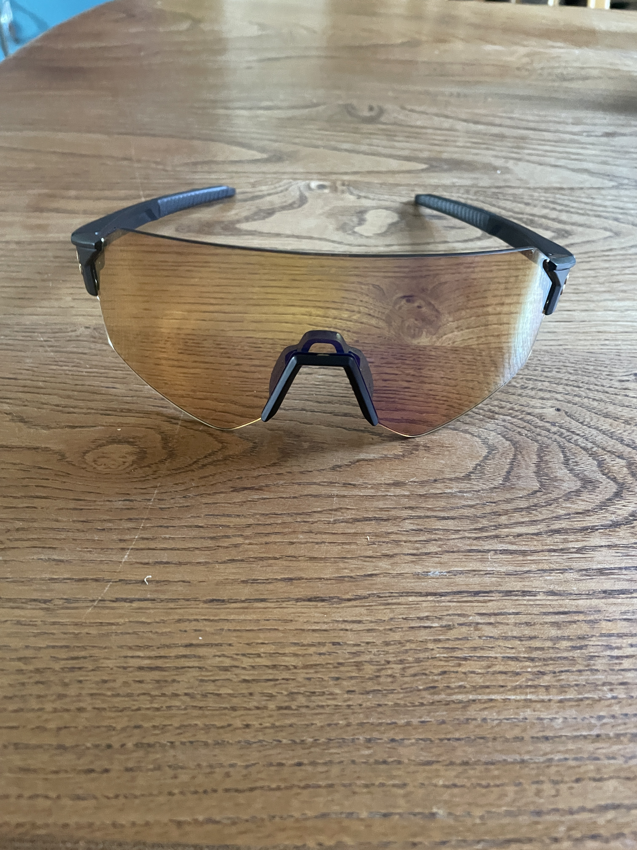 A pair of sunglasses son a wooden tabletop