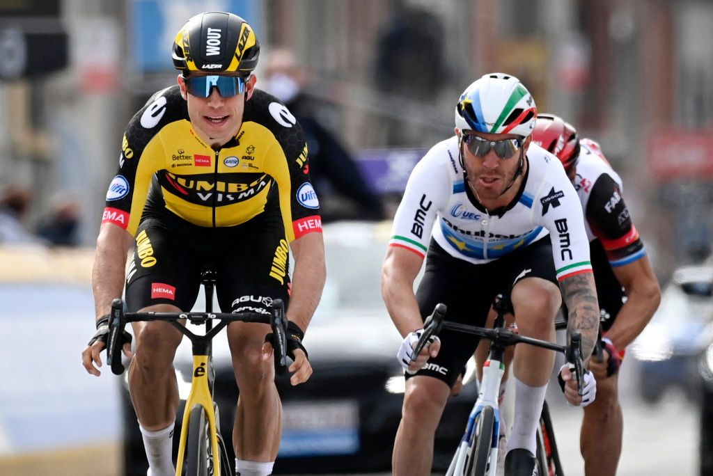 Belgian Wout Van Aert of Team JumboVisma L sprints to win over Italian Giacomo Nizzolo of Qhubeka Assos a at the finish of the GentWevelgem In Flanders Fields 2475 kilometers road cycling race from Ypers to Wevelgem on March 28 2021 Home rider Wout van Aert of JumboVisma won the GentWevelgem cycling classic in Belgium edging Italian pair Giacomo Nizzolo and Matteo Trentin The powerful 26yearold also won the MilanSan Remo and Strade Bianche classics in 2020 and has emerged as a major force in the sport Belgium OUT Photo by DIRK WAEM various sources AFP Belgium OUT Photo by DIRK WAEMBelgaAFP via Getty Images