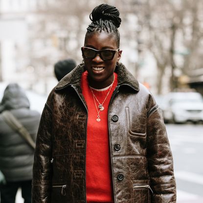 Nikki Ogunnaike wearing a red sweater and a leather jacket 