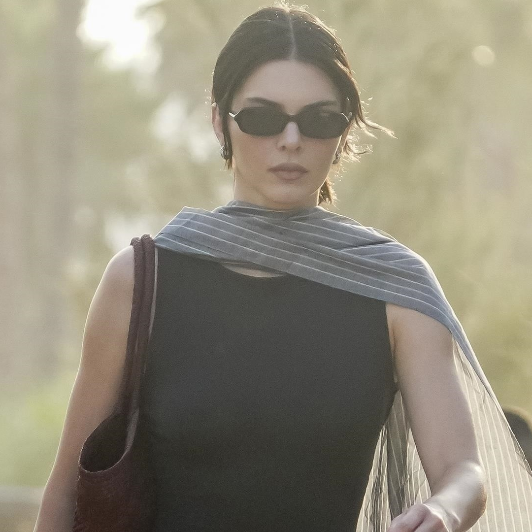 Kendall Jenner wore a little black dress and a pinstripe shawl on vacation with Kylie and Timothée Chalamet
