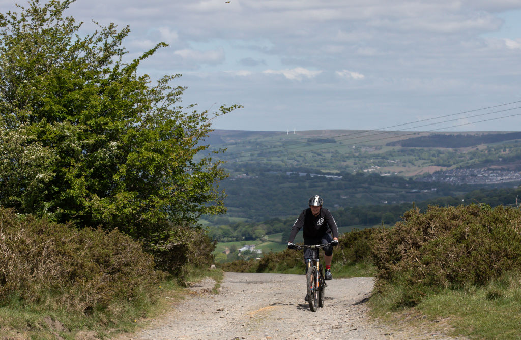 BLACKWOOD, WALES - 11 MAY: A lone cyclist obeying social distancing rides onto the Machen Mountain on May 11, 2020 in Blackwood, Wales, United Kingdom. The prime minister announced the general contours of a phased exit from the current lockdown, adopted nearly two months ago in an effort curb the spread of Covid-19. (Photo by Huw Fairclough/Getty Images)