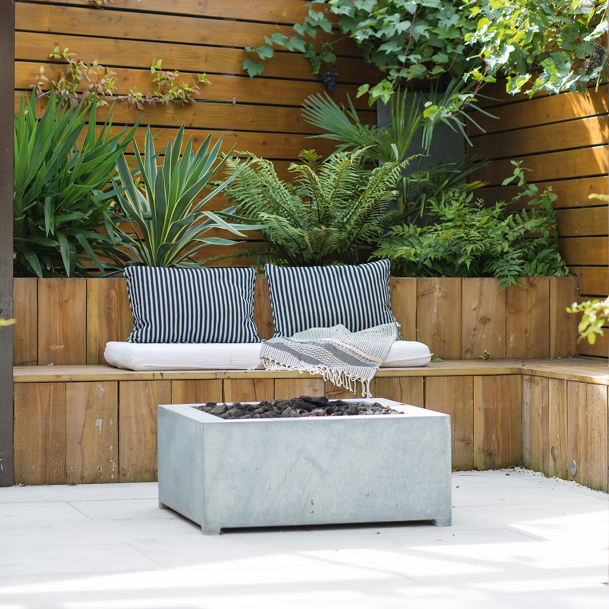 patio area with wooden couch and fire place