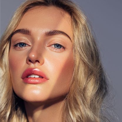 summer makeup looks - beautiful woman shot with sunlight on her face getty 1944687241