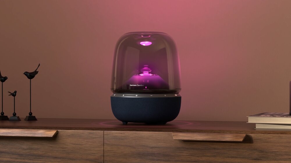 Harman Kardon Aura Studio 5 Wi-Fi glowing pink on a side table