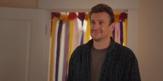 Jason Segel looking on after Dakota Johnson arrives back home in Our Friend