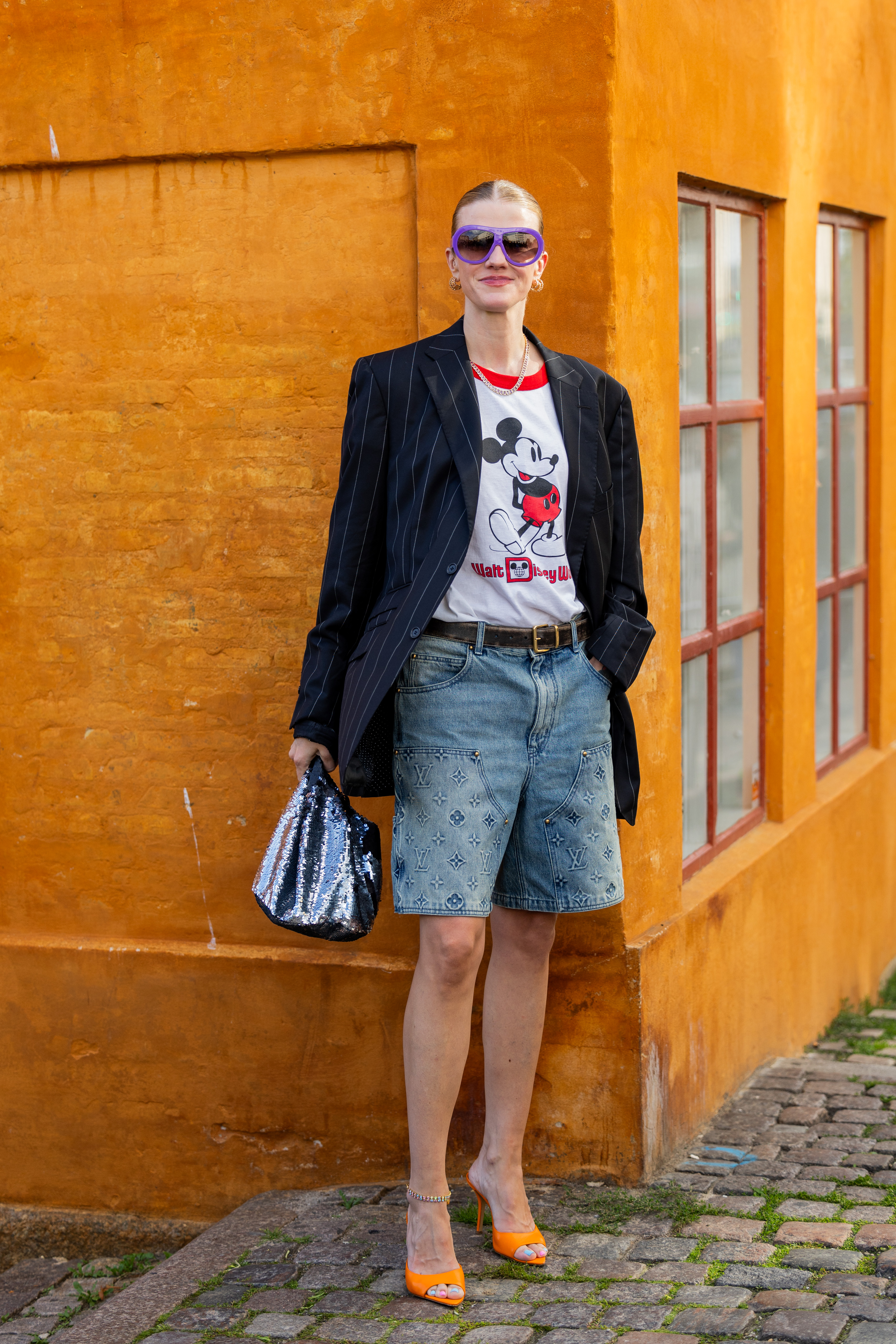 Woman wearing a graphic t shirt and denim shorts