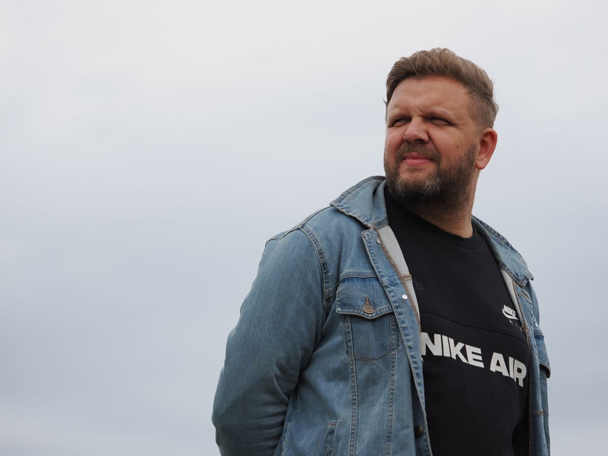 A man standing outside looking into the distance