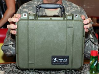 The Traveling TeraByte Project is stored inside a small olive drab-colored Pelican case. The case, which contains a terabyte of media, is shipped around the world to hackers and soldiers who couldn't attend Defcon.