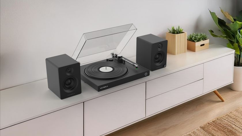 Victrola Wave turntable and Tempo speakers in black on a sideboard