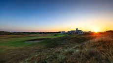 A general view of the 18th hole at Royal Birkdale as the sun sets behind the clubhouse