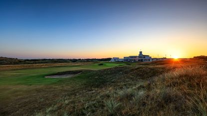 A general view of the 18th hole at Royal Birkdale as the sun sets behind the clubhouse