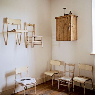 bathroom with chairs nailed to the wall