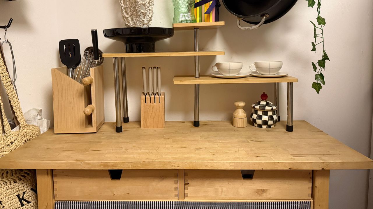 Small kitchen featuring a birch wood IKEA kitchen trolley that is styled with mugs, pots, pans, and other kitchen essentials