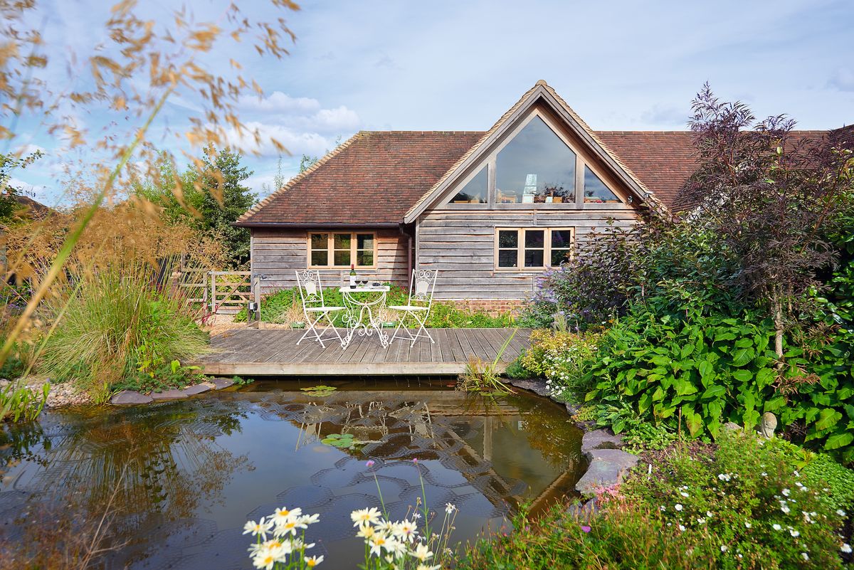 exterior os oak frame self build with large pond