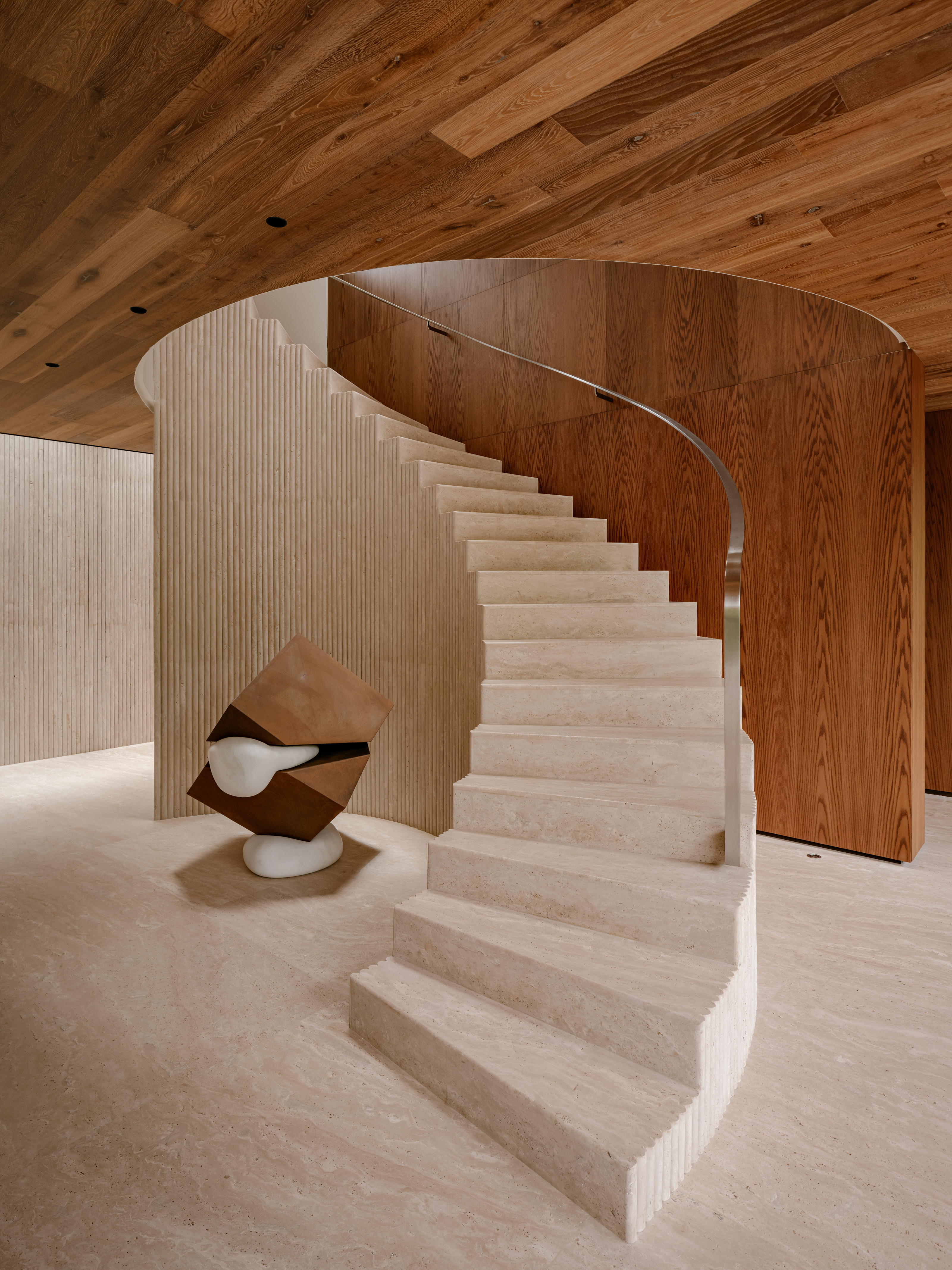 The sculptural stone and wood staircase