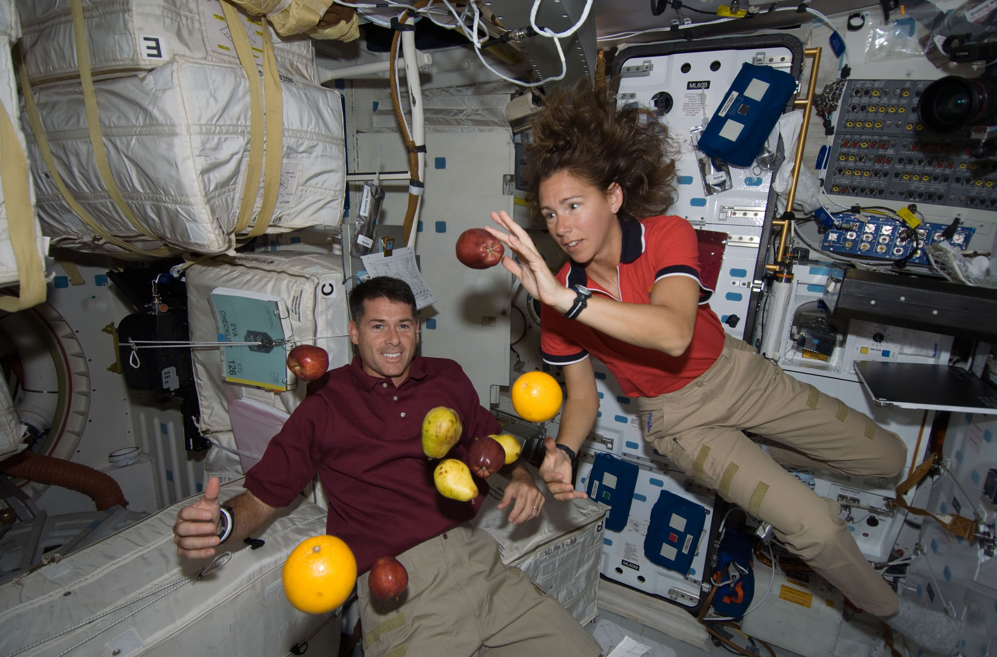 Astronauts Shane Kimbrough and Sandra Magnus Floating with Fruit