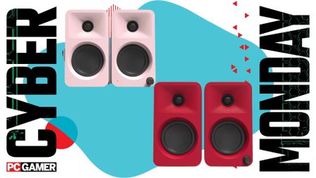 Kanto Ora desktop speakers on a blue background