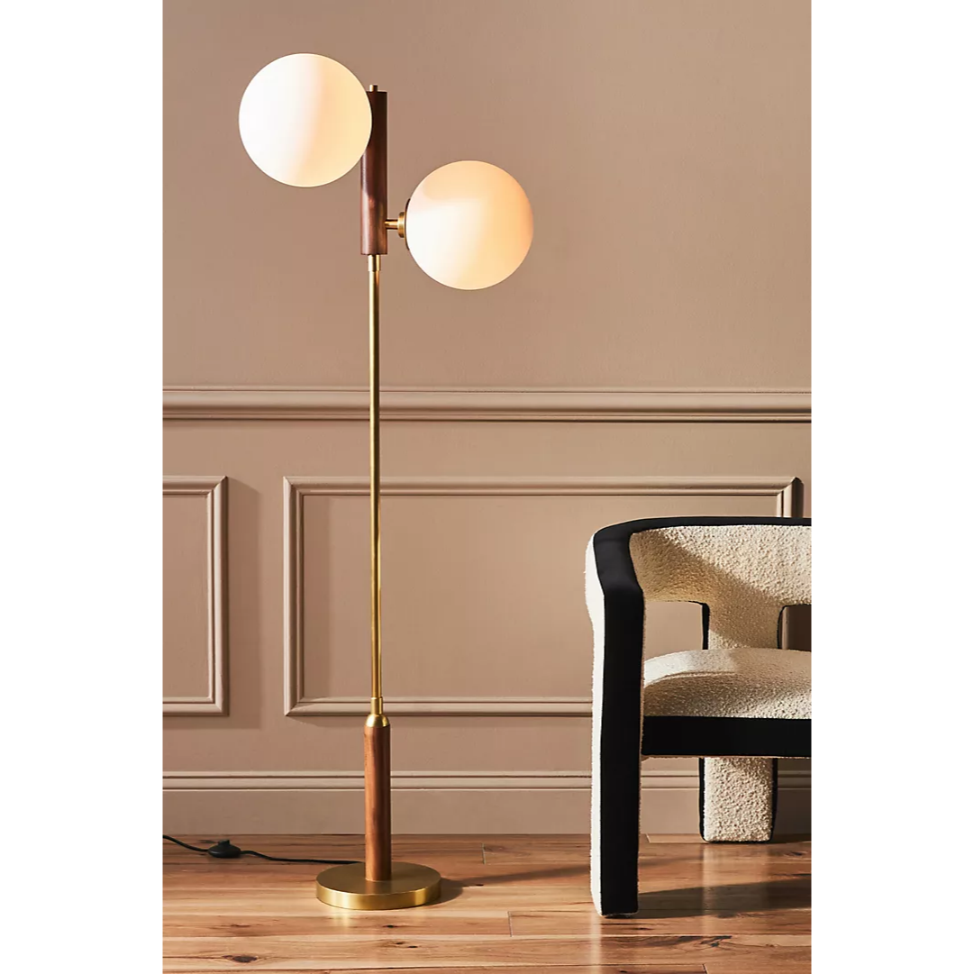 brass floor lamp with two orb lights and walnut accents
