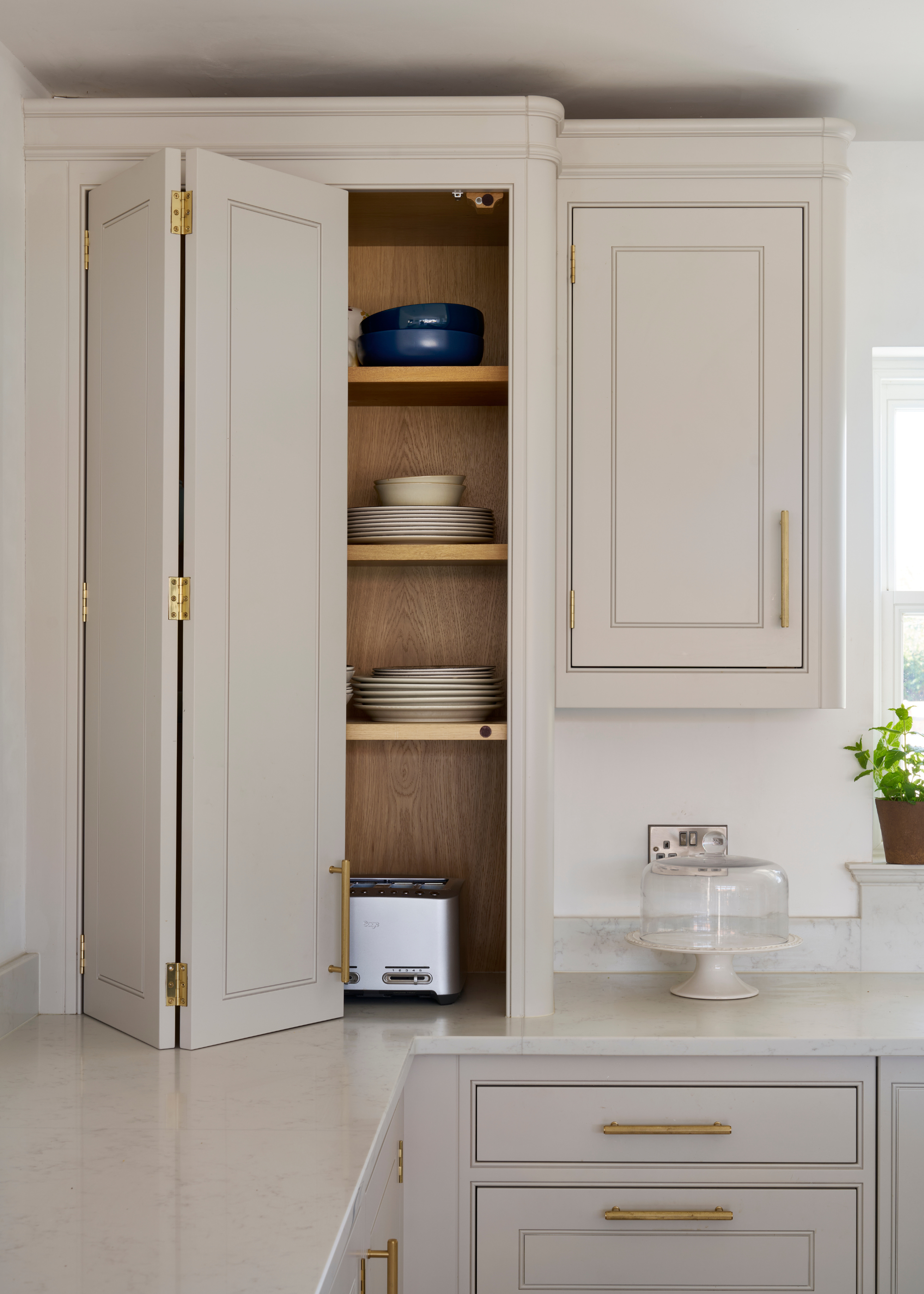 A kitchen island with an open shelf for keeping plates