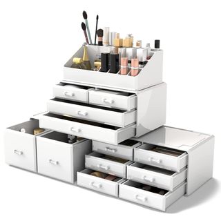 A white plastic organizer with different drawers of different sizes holds makeup