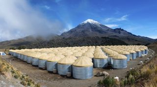 The HAWC gamma-ray observatory detects cosmic rays from its altitude of 13,500 feet in Mexico's Pico de Orizaba National Park. The Sierra Negra volcano looms large in the background.