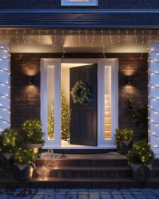 A front porch decorated with Christmas lights