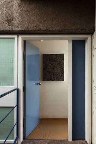 Entrance to Barbican apartment with a blue door
