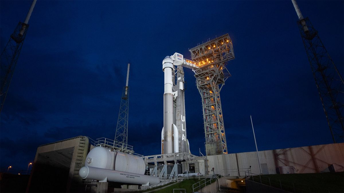 Boeing&#039;s Starliner Capsule Sits Atop The ULA Atlas V Rocket On A Launchpad In Florida At Night