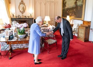 Queen Elizabeth II presents Thomas Trotter with the Queen's Medal for Music at an audience at Windsor Castle