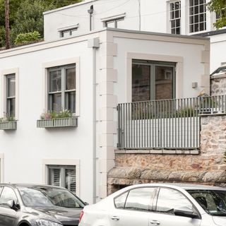 white house with blue window boxes and terrace area