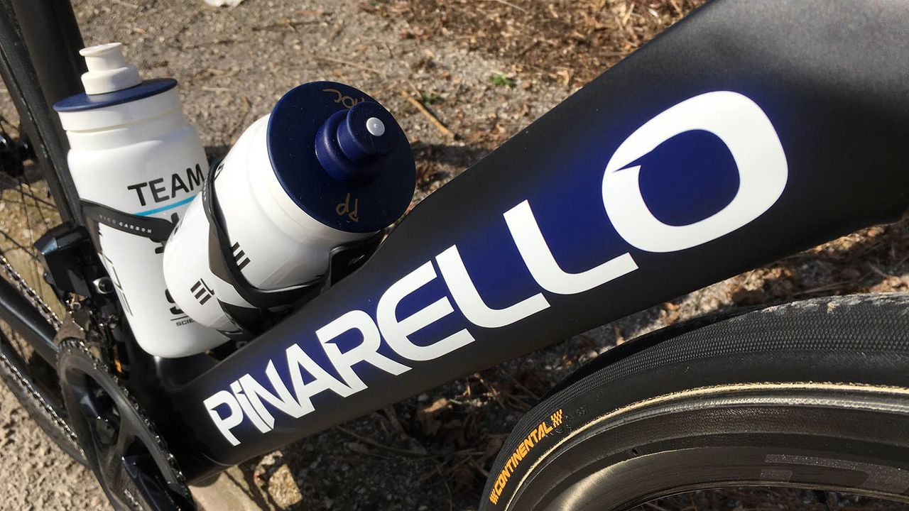 A blue shadow surrounds the white decals on the down tube of the bike