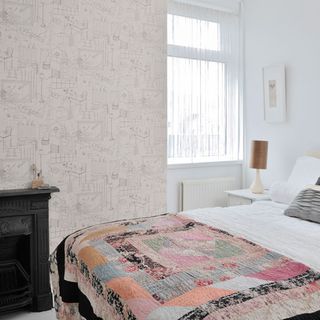 bedroom with white window and wallpaper on wall