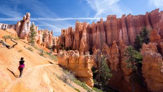 A woman hiking towards hoodoos in Bryce Canyon