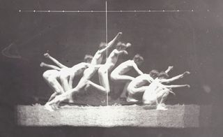 Black and white photo of a male nude, showing the motion of jumping