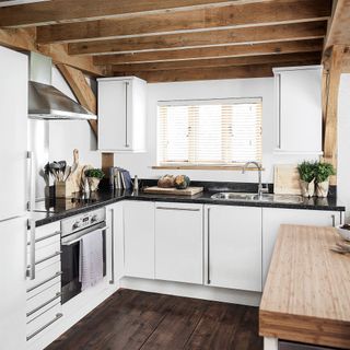 white kitchen with wooden beams