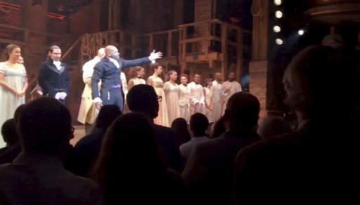 Actor Brandon Victor Dixon speaks to Mike Pence after a performance of Hamilton