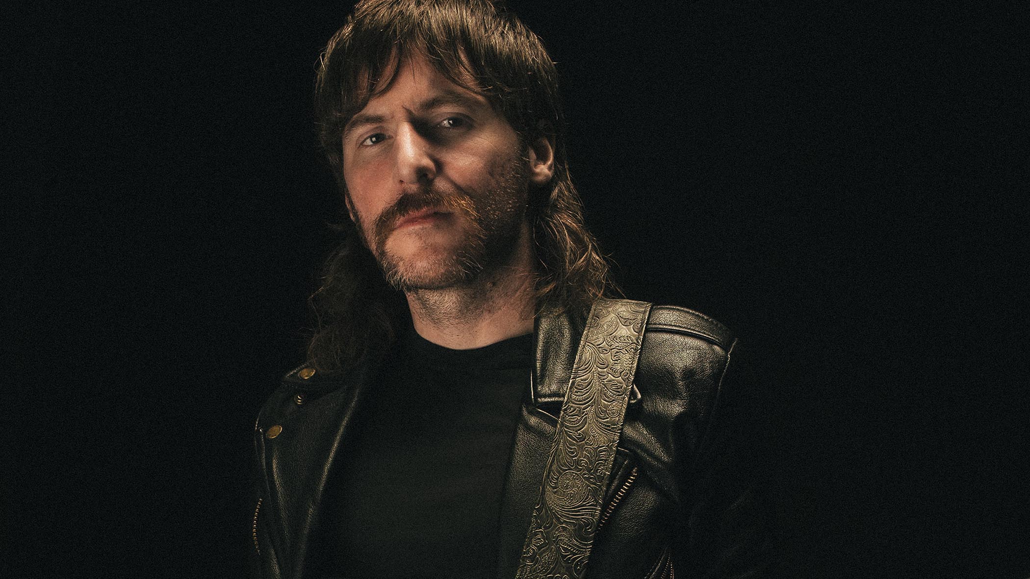 A close-up portrait of Khemmis guitarist Phil Pendergast.
