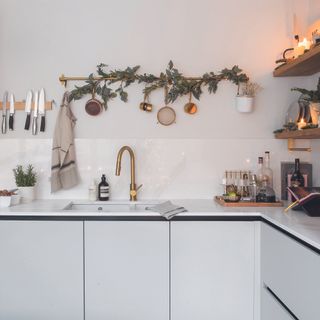 White kitchen with garland on wall