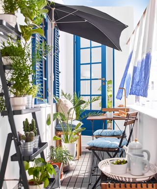 summer balcony with a patio umbrella and curtains for shade