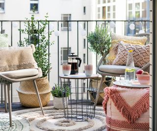 balcony seating area with table, chairs and floor pouffe