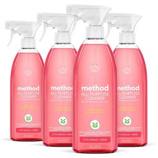 A side on view of 4 bottles of Method pink grapefruit anti-bac all purpose cleaner