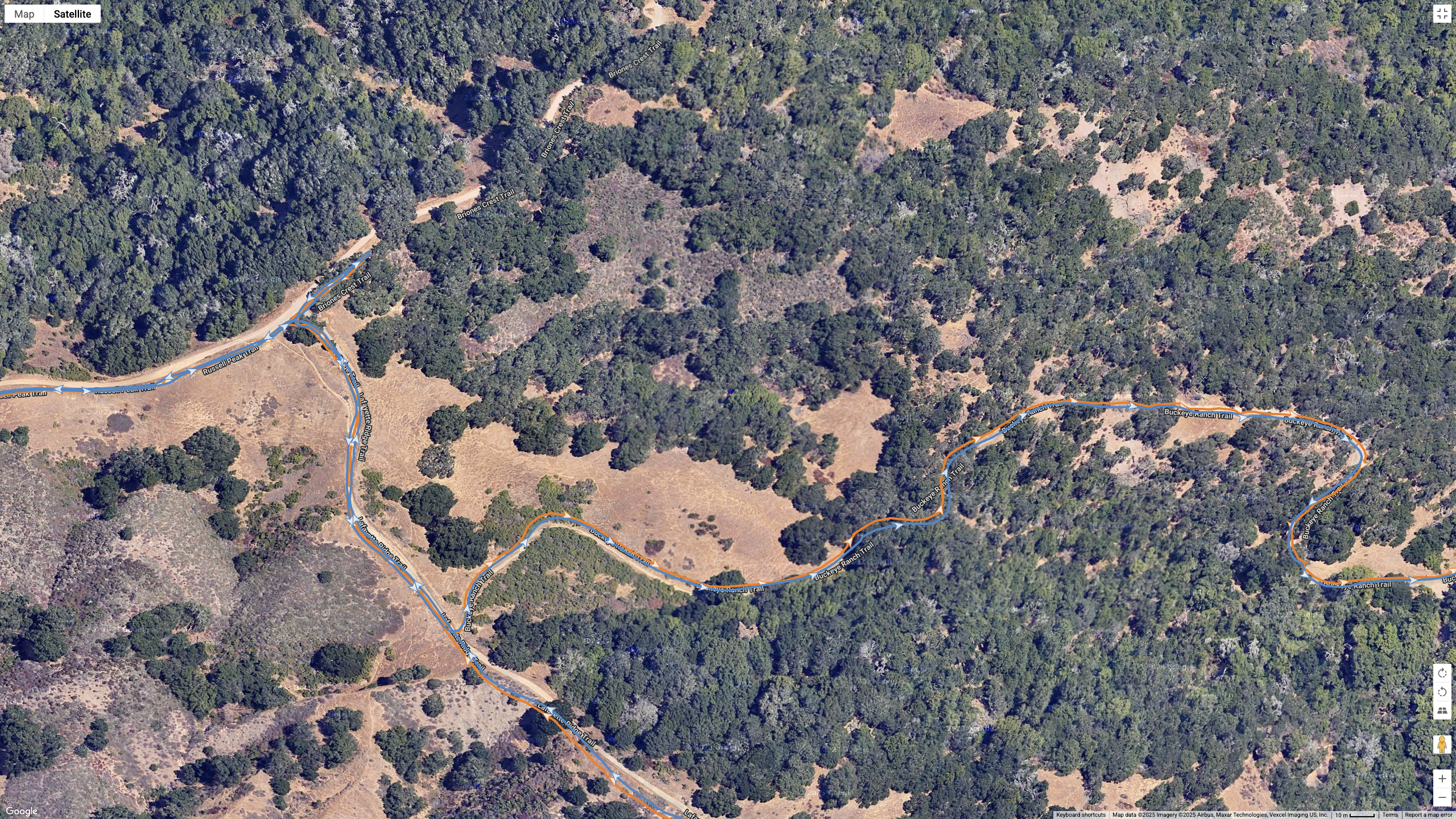A Google Maps satellite view showing how the COROS APEX 4 (blue) and Garmin Forerunner 970 (orange) compare for GPS-tracked accuracy on a hilly, windy hike.