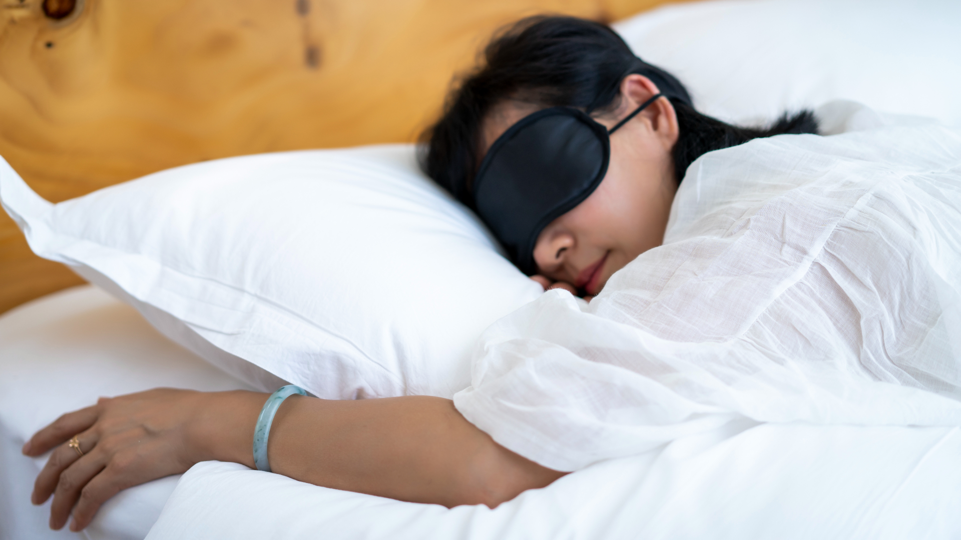 A woman sleeping with an eyemask on.