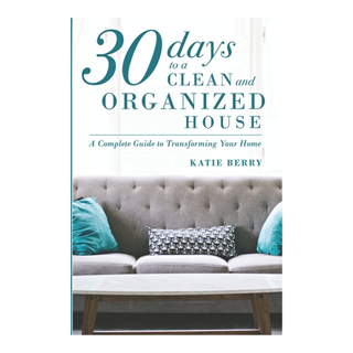 A paperback book titled '30 Days To A Clean And Organized House' by Katie Berry