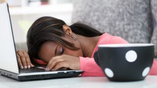 Woman sleeping on laptop