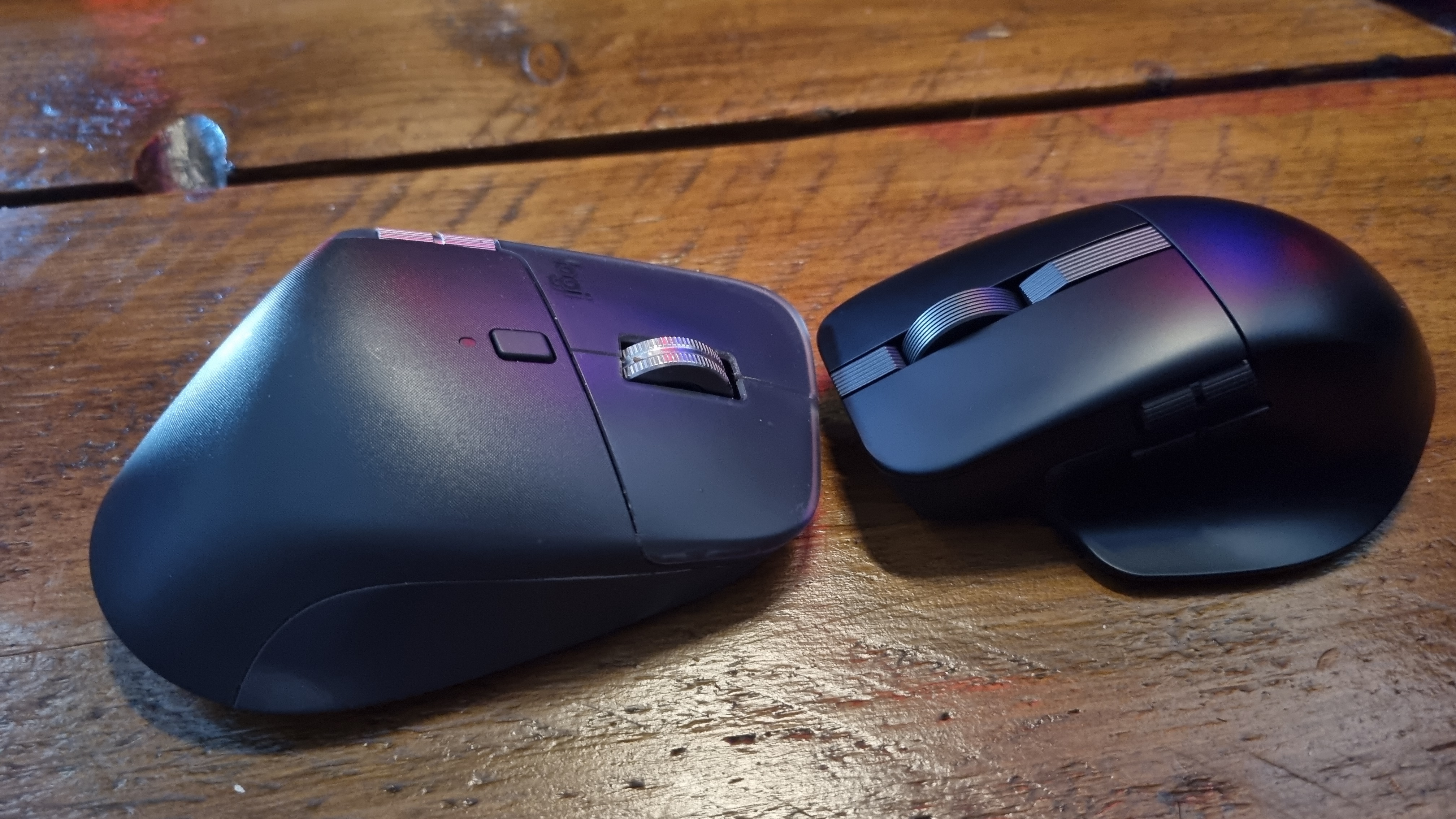 An Asus ProArt Mouse MD301 sitting nose-to-nose with a Logitech MX Master 4